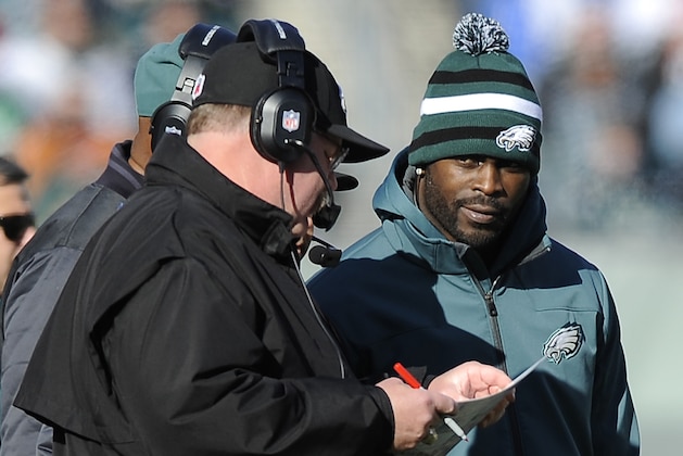 FILE - In a Sunday, Dec. 23, 2012 photo, Philadelphia Eagles coach Andy Reid, left, and quarterback Michael Vick look at a play card on the sideline in the first half of an NFL football game against the Washington Redskins, in Philadelphia. Reid has been fired after 14 seasons coaching the Philadelphia Eagles. The Eagles made the announcement Monday, Dec. 31, 2012. (AP Photo/Michael Perez, File)