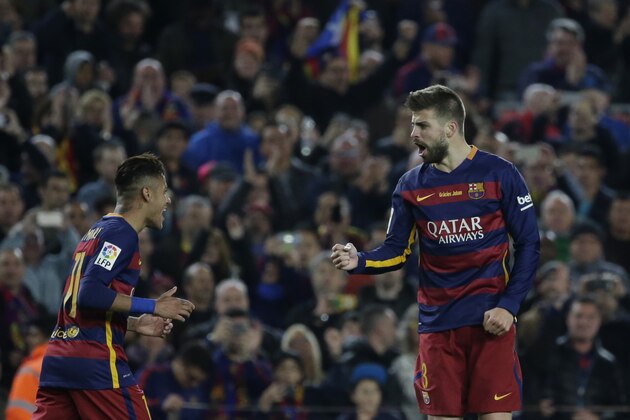 Barcelona's Gerard Pique, right, celebrates scoring his side's first goal with Neymar during a Spanish La Liga soccer match between Barcelona and Real Madrid, dubbed 'el clasico', at the Camp Nou stadium in Barcelona, Spain, Saturday, April 2, 2016. (AP Photo/Emilio Morenatti)