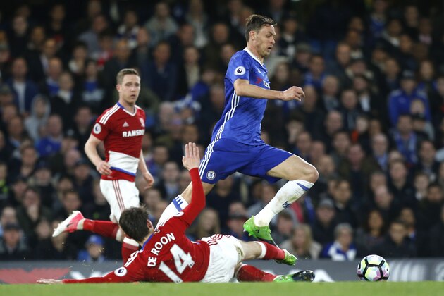 Chelsea's Serbian midfielder Nemanja Matic (R) skips a tackle by Middlesbrough's Dutch midfielder Marten de Roon during the English Premier League football match between Chelsea and Middlesbrough at Stamford Bridge in London on May 8, 2017. / AFP PHOTO / Ian KINGTON / RESTRICTED TO EDITORIAL USE. No use with unauthorized audio, video, data, fixture lists, club/league logos or 'live' services. Online in-match use limited to 75 images, no video emulation. No use in betting, games or single club/league/player publications.  /         (Photo credit should read IAN KINGTON/AFP/Getty Images)