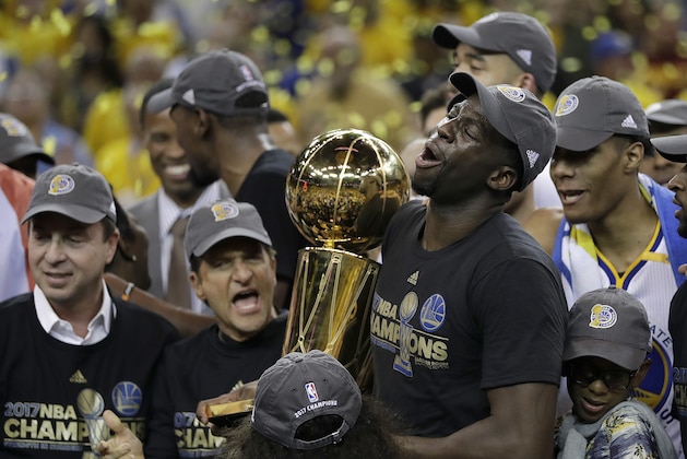 Golden State Warriors forward Draymond Green (23) holds the Larry O'Brien NBA Championship Trophy after Game 5 of basketball's NBA Finals against the Cleveland Cavaliers in Oakland, Calif., Monday, June 12, 2017. The Warriors won 129-120 to win the NBA championship. (AP Photo/Marcio Jose Sanchez)