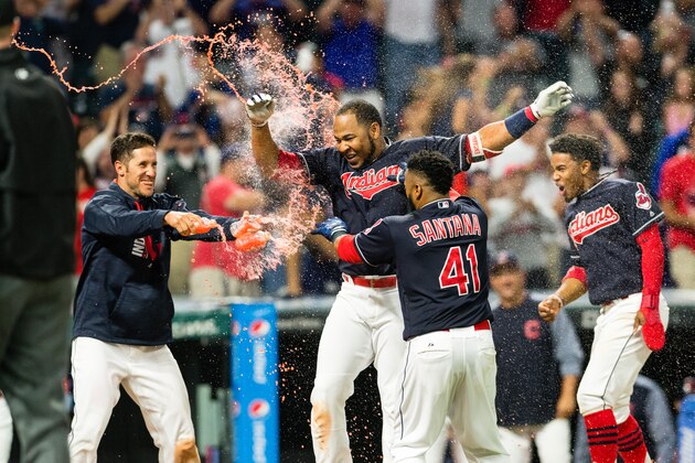 CLEVELAND, OH - JULY 25: Yan Gomes #7, Carlos Santana #41 and Francisco Lindor #12 of the Cleveland Indians celebrate with Edwin Encarnacion #10 after Encarnacion hit a walk-off grand slam home run to defeat the Los Angeles Angels of Anaheim in the eleventh inning at Progressive Field on July 25, 2017 in Cleveland, Ohio. The Indians defeated the Angels 11-7. (Photo by Jason Miller/Getty Images)