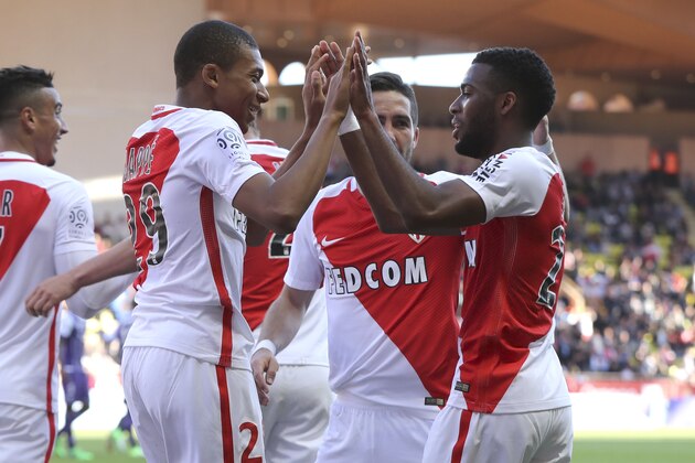 Monaco's French midfielder Thomas Lemar (R) celebrates after scoring a goal with Monaco's French forward Kylian Mbappe Lottin (L) during the French L1 football match Monaco (ASM) vs Toulouse (TFC) on April 29, 2017 at the 'Louis II Stadium' in Monaco. / AFP PHOTO / VALERY HACHE        (Photo credit should read VALERY HACHE/AFP/Getty Images)