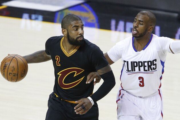 Cleveland Cavaliers' Kyrie Irving (2) looks to pass against Los Angeles Clippers' Chris Paul (3) during the second half of an NBA basketball game Thursday, Dec 1, 2016, in Cleveland. (AP Photo/Ron Schwane)