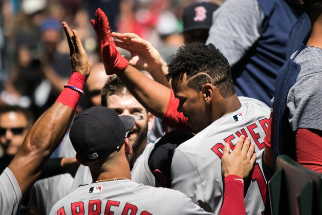 SEATTLE, WA - JULY 26: Rafael Devers #11 of the Boston Red Sox is mobbed by teammates, including Deven Marrero #17 as they celebrate his first career hit, a home run to center field off of Andrew Moore #48 of the Seattle Mariners in the third inning at Safeco Field on July 26, 2017 in Seattle, Washington. (Photo by Lindsey Wasson/Getty Images)