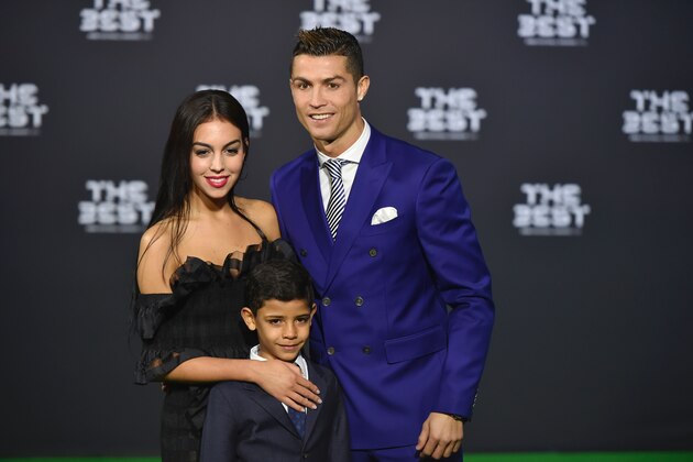 Real Madrid and Portugal's forward Cristiano Ronaldo poses with partner Georgina Rodriguez and his son Cristiano Ronaldo Jr as they arrive for The Best FIFA Football Awards 2016 ceremony, on January 9, 2017 in Zurich. / AFP / MICHAEL BUHOLZER        (Photo credit should read MICHAEL BUHOLZER/AFP/Getty Images)