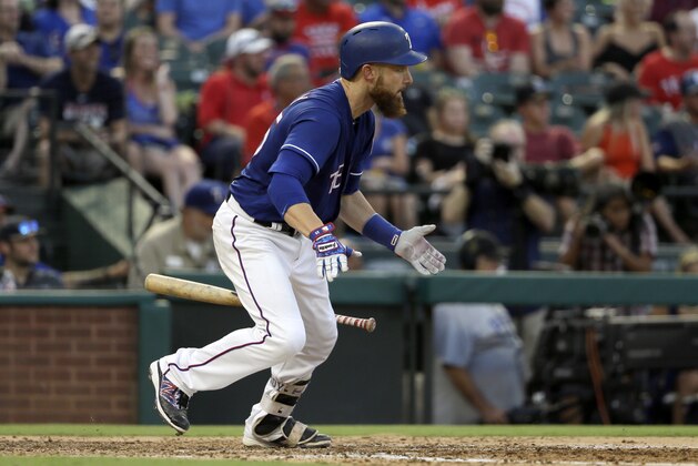 Texas Rangers' Jonathan Lucroy follows through on a run-scoring fielders choice in the third inning of a baseball game against the Miami Marlins on Tuesday, July 25, 2017, in Arlington, Texas. The Rangers' Nomar Mazara scored on the play. (AP Photo/Tony Gutierrez)
