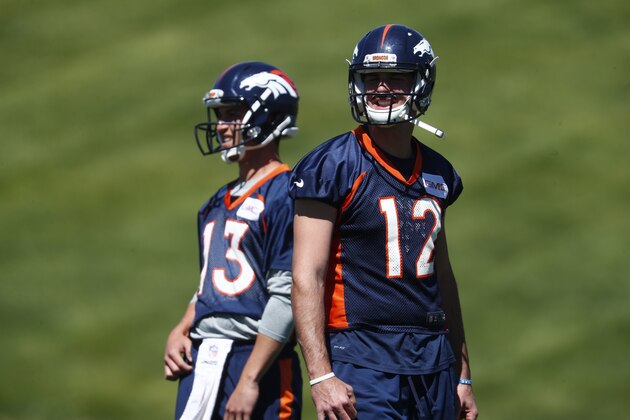Denver Broncos quarterbacks Paxton Lynch (12) and Trevor Siemian during drills at the team's mandatory minicamp session Thursday, June 15, 2017, at the Broncos' headquarters in Englewood, Colo. (AP Photo/David Zalubowski)