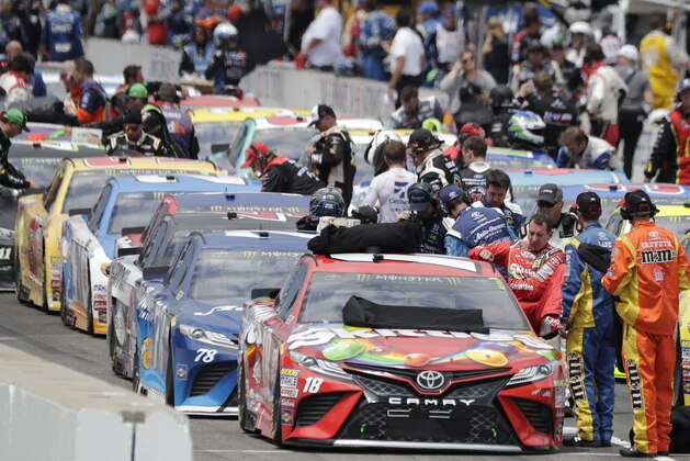 Kyle Busch climbs out of his car after the NASCAR Brickyard 400 auto race was red-flagged after 12 laps at Indianapolis Motor Speedway in Indianapolis, Sunday, July 23, 2017. The race was stopped due to severe weather. (AP Photo/Darron Cummings)