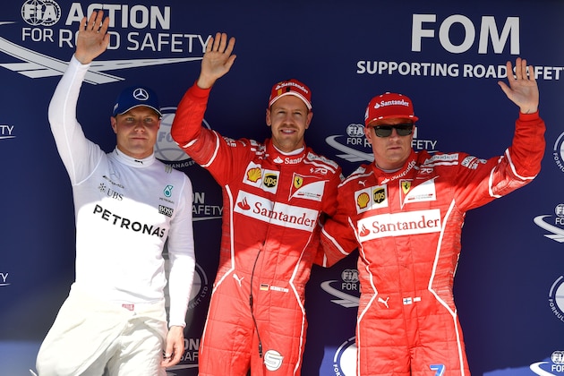 Ferrari's German driver Sebastian Vettel (C), Ferrari's Finnish driver Kimi Raikkonen (R) and Mercedes' Finnish driver Valtteri Bottas (L) pose after the qualifying at the Hungaroring racing circuit in Budapest on July 29, 2017 prior to the Formula One Hungarian Grand Prix. / AFP PHOTO / ANDREJ ISAKOVIC        (Photo credit should read ANDREJ ISAKOVIC/AFP/Getty Images)