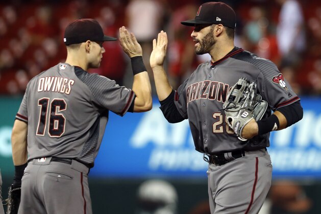 Arizona Diamondbacks' J.D. Martinez, right, and Chris Owings celebrate following the team's 4-0 victory over the St. Louis Cardinals in a baseball game Thursday, July 27, 2017, in St. Louis. (AP Photo/Jeff Roberson)