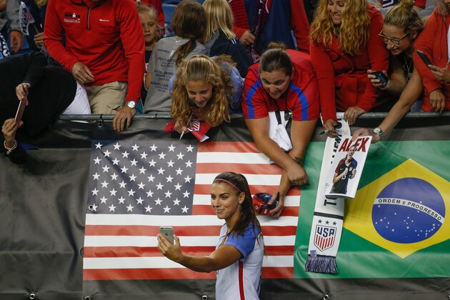 SEATTLE, WA - JULY 27:  Alex Morgan #13 of the United States shoots a selfie with fans following the match against Australia during the 2017 Tournament of Nations at CenturyLink Field on July 27, 2017 in Seattle, Washington.  (Photo by Otto Greule Jr/Getty Images)