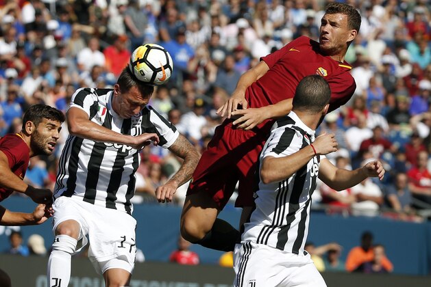 Juventus' Mario Mandzukic, left, and Gonzalo Higuain defend against AS Roma's Edin Dzeko, top, during the first half of an International Champions Cup match, Sunday, July 30, 2017, in Foxborough, Mass. (AP Photo/Michael Dwyer)
