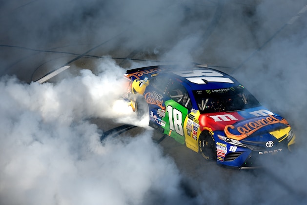 LONG POND, PA - JULY 30:  Kyle Busch, driver of the #18 M&M's Caramel Toyota, celebrates with a burnout after winning the Monster Energy NASCAR Cup Series Overton's 400 at Pocono Raceway on July 30, 2017 in Long Pond, Pennsylvania.  (Photo by Jared C. Tilton/Getty Images)