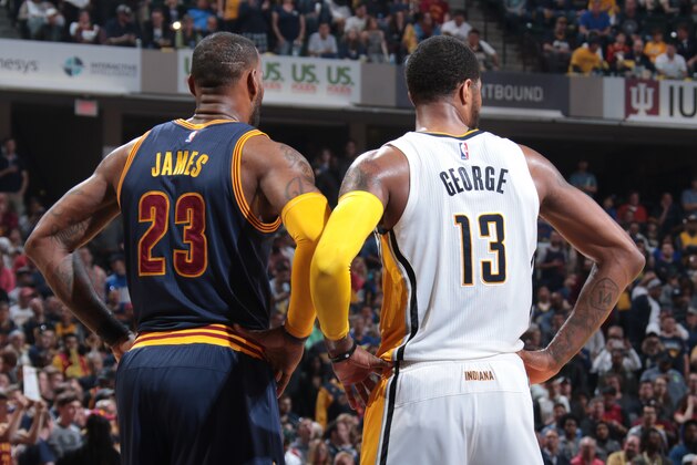 INDIANAPOLIS, IN - APRIL 23:  LeBron James #23 of the Cleveland Cavaliers and Paul George #13 of the Indiana Pacers look on during Game Four of the Eastern Conference Quarterfinals of the 2017 NBA Playoffs on April 23, 2017 at Bankers Life Fieldhouse in Indianapolis, Indiana. NOTE TO USER: User expressly acknowledges and agrees that, by downloading and/or using this photograph, user is consenting to the terms and conditions of the Getty Images License Agreement. Mandatory Copyright Notice: Copyright 2017 NBAE (Photo by Ron Hoskins/NBAE via Getty Images)