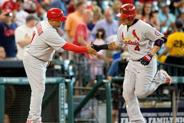HOUSTON - JUNE 26:  Yadier Molina #4 of the St. Louis Cardinals receives congratulations from Jose Oquendo #11 of the St. Louis Cardinals after hitting a home run in the first inning against the Houston Astros at Minute Maid Park on June 26, 2013 in Houston, Texas.  (Photo by Bob Levey/Getty Images)