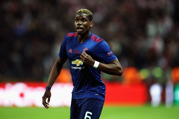 STOCKHOLM, SWEDEN - MAY 24:  Paul Pogba of Manchester United points to the Manchester United badge on his kit following victory in the UEFA Europa League Final between Ajax and Manchester United at Friends Arena on May 24, 2017 in Stockholm, Sweden.  (Photo by Julian Finney/Getty Images)