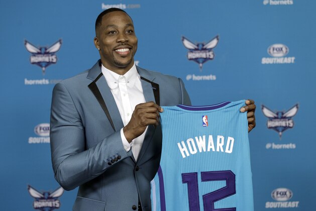 Charlotte Hornets' Dwight Howard poses for a photo holding his new jersey during an NBA basketball news conference in Charlotte, N.C., Monday, June 26, 2017 after being traded to the Hornets by the Atlanta Hawks last week. (AP Photo/Chuck Burton)