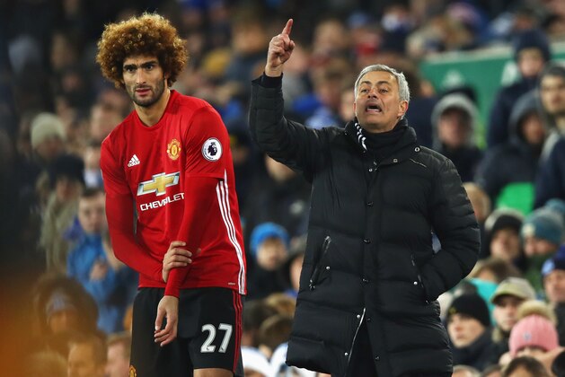 LIVERPOOL, ENGLAND - DECEMBER 04:  Jose Mourinho manager of Manchester United stands alongside substitute Marouane Fellaini of Manchester United during the Premier League match between Everton and Manchester United at Goodison Park on December 4, 2016 in Liverpool, England.  (Photo by Clive Brunskill/Getty Images)
