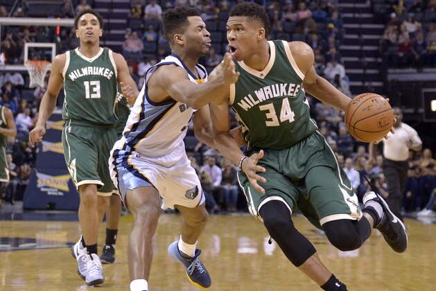 Milwaukee Bucks forward Giannis Antetokounmpo (34) drives against Memphis Grizzlies guard Andrew Harrison as Bucks guard Malcolm Brogdon (13) looks on in the first half of an NBA basketball game Monday, March 13, 2017, in Memphis, Tenn. (AP Photo/Brandon Dill)