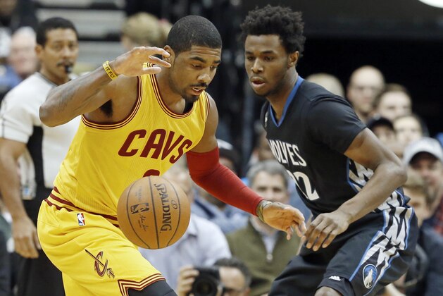 Cleveland Cavaliers’ Kyrie Irving, left, watches the ball with Minnesota Timberwolves’ Andrew Wiggins in the first quarter of an NBA basketball game, Friday, Jan. 8, 2016, in Minneapolis. (AP Photo/Jim Mone)