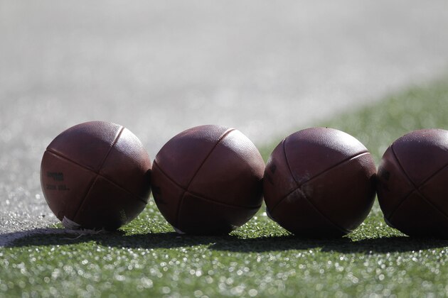 Footballs are lined up on the fielld before an NFL football game between the Washington Redskins and the New York Giants, Sunday, Dec. 18, 2011, in East Rutherford, N.J. (AP Photo/Julio Cortez)