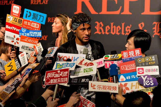 Brazilian footballer Neymar Jr. looks on as he speaks to media at a fashion event in Shanghai on July 31, 2017. 
Neymar hit the red carpet in Shanghai on July 31 as speculation mounted that the Brazil star could be set to quit Barcelona for Paris Saint-Germain for a world-record 222 million euros. / AFP PHOTO / CHANDAN KHANNA        (Photo credit should read CHANDAN KHANNA/AFP/Getty Images)