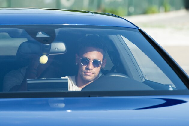 TOPSHOT - Barcelona's Brazilian forward Neymar drives into the parkinglot to takes part in a training session at the Sports Center FC Barcelona Joan Gamper in Sant Joan Despi, near Barcelona on August 2, 2017 following rumour that Neymar is considering a move to French club PSG for which the club would have to shell out some 222 million euros, enough to trigger the 25-year-old's transfer release clause. / AFP PHOTO / Josep LAGO        (Photo credit should read JOSEP LAGO/AFP/Getty Images)