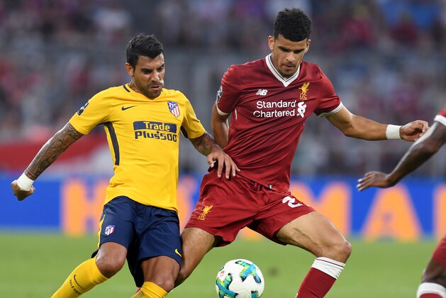 Liverpool's defender Dominic Solanke (R) and Atletico Madrid's Argentinian midfielder Augusto (L) vie for the ball during the final Audi Cup football match between Atletico Madrid and FC Liverpool in the stadium in Munich, southern Germany, on August 2, 2017.  / AFP PHOTO / Christof STACHE        (Photo credit should read CHRISTOF STACHE/AFP/Getty Images)