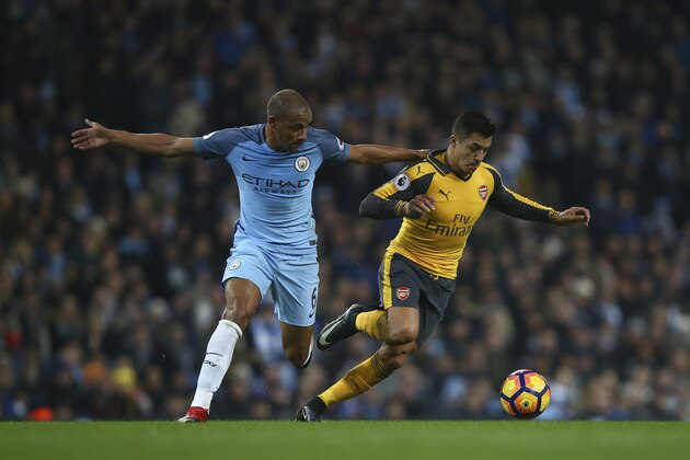 Manchester City's Fernando and Arsenal's Alexis Sanchez during the English Premier League soccer match between Manchester City and Arsenal at the Etihad Stadium in Manchester, England, Sunday, Dec. 18, 2016. (AP Photo/Dave Thompson)