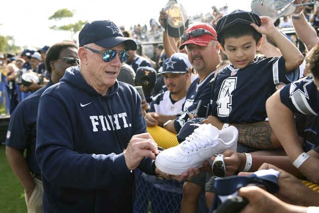 Dallas Cowboys owner Jerry Jones gives autographs during practice at the NFL football team's training camp in Oxnard, Calif., Monday, July 24, 2017. (AP Photo/Michael Owen Baker)