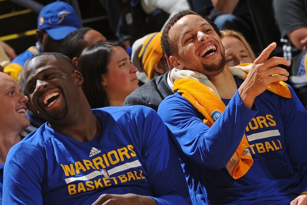 OAKLAND, CA - NOVEMBER 24:  Draymond Green #23 and Stephen Curry #30 of the Golden State Warriors smile and laugh on the bench during the game against the Los Angeles Lakers on November 24, 2015 at ORACLE Arena in Oakland, California. NOTE TO USER: User expressly acknowledges and agrees that, by downloading and or using this Photograph, user is consenting to the terms and conditions of the Getty Images License Agreement. Mandatory Copyright Notice: Copyright 2015 NBAE (Photo by Noah Graham/NBAE via Getty Images)
