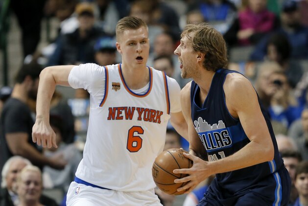 New York Knicks forward Kristaps Porzingis (6) of Latvia defends as Dallas Mavericks' Dirk Nowitzki of Germany prepares to take a shot in the first half of an NBA basketball game, Wednesday, Jan. 25, 2017, in Dallas. (AP Photo/Tony Gutierrez)