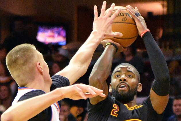 CLEVELAND, OH - OCTOBER 25:  Kyrie Irving #2 of the Cleveland Cavaliers puts up a jump shot over Kristaps Porzingis #6 of the New York Knicks in the third quarter on October 25, 2016 at Quicken Loans Arena in Cleveland, Ohio. Cleveland defeated New York 117-88. NOTE TO USER: User expressly acknowledges and agrees that, by downloading and or using this photograph, User is consenting to the terms and conditions of the Getty Images License Agreement. (Photo by Jamie Sabau/Getty Images)
