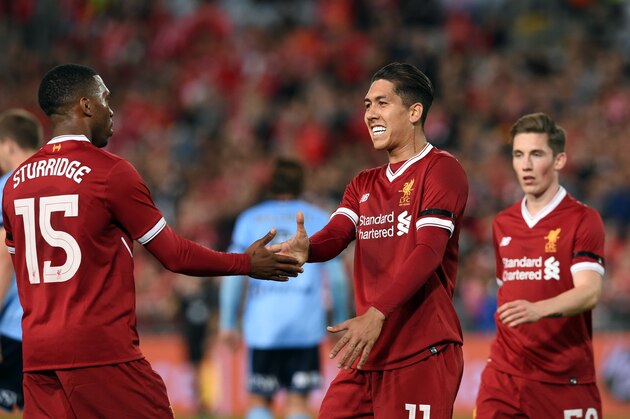 Liverpool's Daniel Sturridge (L) congratulates teammate Roberto Firmino (C) after his goal against Sydney FC during their end-of-season friendly football match at the Olympic Stadium in Sydney on May 24, 2017. / AFP PHOTO / SAEED KHAN / IMAGE RESTRICTED TO EDITORIAL USE - STRICTLY NO COMMERCIAL USE        (Photo credit should read SAEED KHAN/AFP/Getty Images)