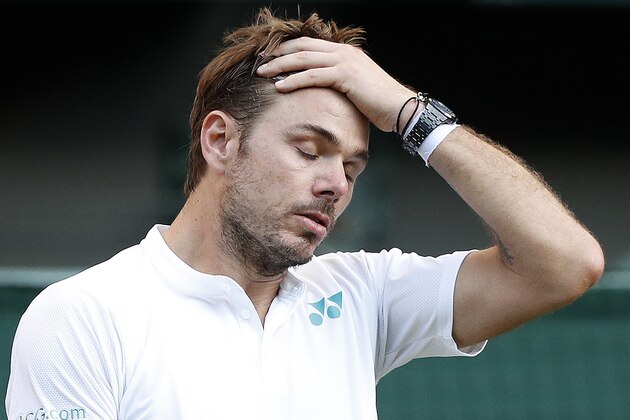TOPSHOT - Switzerland's Stan Wawrinka reacts against Russia's Daniil Medvedev during their men's singles first round match on the first day of the 2017 Wimbledon Championships at The All England Lawn Tennis Club in Wimbledon, southwest London, on July 3, 2017.
Medvedev won 6-4, 3-6, 6-4, 6-1. / AFP PHOTO / Adrian DENNIS / RESTRICTED TO EDITORIAL USE        (Photo credit should read ADRIAN DENNIS/AFP/Getty Images)