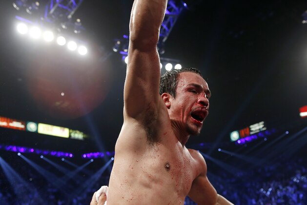 Juan Manuel Marquez, from Mexico, left, celebrates his win over Manny Pacquiao in their WBO world welterweight  fight Saturday, Dec. 8, 2012, in Las Vegas. (AP Photo/Eric Jamison)