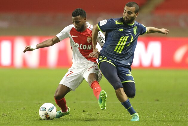 Monaco's Thomas Lemar, left, challenges for the ball with Lille's Naim Sliti during a League One soccer match between Monaco and Lille, at the Louis II stadium, in Monaco, Sunday, May, 14 2017. (AP Photo/Claude Paris)