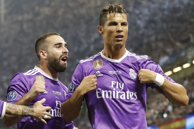 Real Madrid's Cristiano Ronaldo, right, celebrates after scoring the opening goal during the Champions League final soccer match between Juventus and Real Madrid at the Millennium stadium in Cardiff, Wales Saturday June 3, 2017. (AP Photo/Frank Augstein)