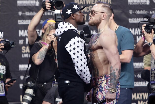 This July 13, 2017 photo shows Floyd Mayweather Jr., left, and Conor McGregor, of Ireland, facing each other for photos during a news conference at Barclays Center in New York. So far fans aren't exactly storming the box office to buy tickets for Mayweather Jr.'s fight next month with McGregor. A check online Saturday, July 29, 2017 revealed hundreds _ even thousands _ of seats still available from Ticketmaster at the T-Mobile arena for the Aug. 26 fight. There are so many open seats that fans with enough room left on their credit cards can buy six tickets together in 162 different spots throughout the arena. (AP Photo/Frank Franklin II) This July 13, 2017 photo shows Floyd Mayweather Jr., left, and Conor McGregor, of Ireland, facing each other for photos during a news conference at Barclays Center in New York. So far fans aren't exactly storming the box office to buy tickets for Mayweather Jr.'s fight next month with McGregor. A check online Saturday, July 29, 2017 revealed hundreds _ even thousands _ of seats still available from Ticketmaster at the T-Mobile arena for the Aug. 26 fight. There are so many open seats that fans with enough room left on their credit cards can buy six tickets together in 162 different spots throughout the arena. (AP Photo/Frank Franklin II)