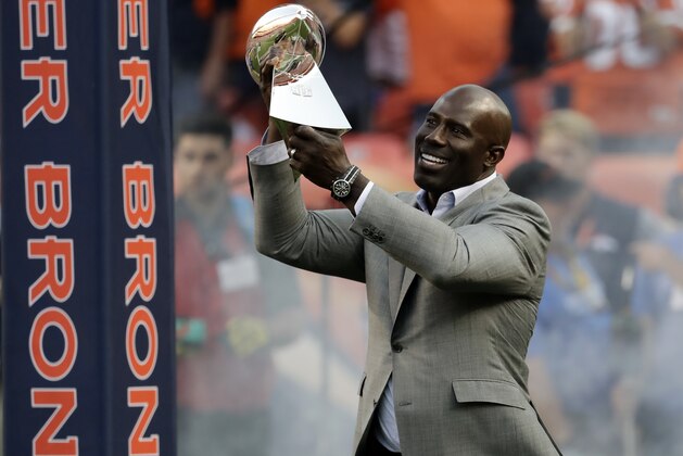 FILE - In this Sept. 8, 2016, file photo, Super Bowl XXXII MVP Terrell Davis carries the Lombardi Trophy onto the field prior to an NFL football game between the Denver Broncos and the Carolina Panthers, in Denver. Davis is the only running back with back-to-back Super Bowl titles, an MVP trophy, a Super Bowl MVP honor, a 2,000-yard season and seven consecutive playoff wins in which he topped 100 yards rushing. Davis will be inducted into the Pro Football Hall of Fame on Saturday, Aug. 5, 2017.   (AP Photo/Jack Dempsey, File)
