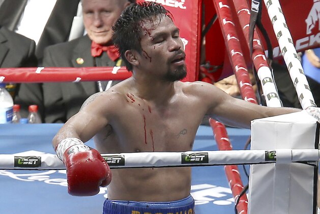 In this Sunday, July 2, 2017, file photo, Manny Pacquiao of the Philippines reacts after his loss to Jeff Horn of Australia, during their WBO World Welterweight title fight in Brisbane, Australia. (AP Photo/Tertius Pickard, File)