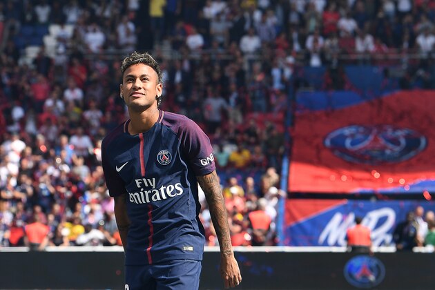 TOPSHOT - Paris Saint-Germain's Brazilian forward Neymar looks on during his presentation to the fans at the Parc des Princes stadium in Paris on August 5, 2017.
Brazil superstar Neymar will watch from the stands as Paris Saint-Germain open their season on August 5, 2017, but the French club have already clawed back around a million euros on their world record investment. Neymar, who signed from Barcelona for a mind-boggling 222 million euros ($264 million), is presented to the PSG support prior to his new team's first game of the Ligue 1 campaign against promoted Amiens.
 / AFP PHOTO / ALAIN JOCARD        (Photo credit should read ALAIN JOCARD/AFP/Getty Images)