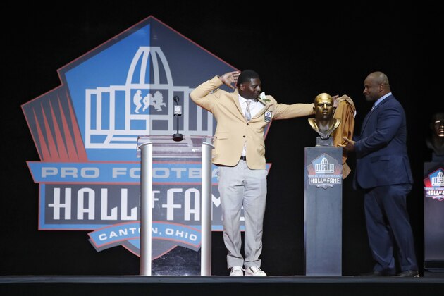 CANTON, OH - AUGUST 05: LaDainian Tomlinson reacts as he and presenter Lorenzo Neal unveil Tomlinson's bust during the Pro Football Hall of Fame Enshrinement Ceremony at Tom Benson Hall of Fame Stadium on August 5, 2017 in Canton, Ohio. (Photo by Joe Robbins/Getty Images)