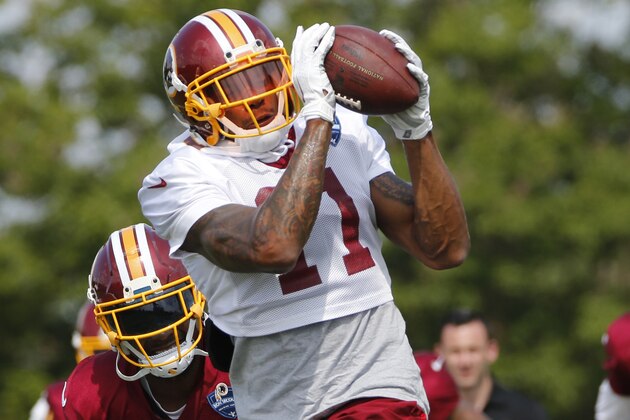 Washington Redskins wide receiver Terrelle Pryor (11) hauls in a pass in front of cornerback Josh Norman (24) during practice at the Washington Redskins NFL training camp in Richmond, Va., Tuesday, Aug. 1, 2017. (AP Photo/Steve Helber)