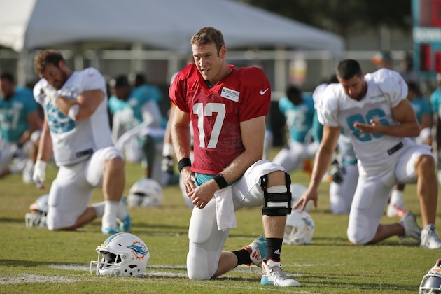Miami Dolphins quarterback Ryan Tannehill stretches out during an NFL football training camp, Thursday, Aug. 3, 2017, at the Dolphins training facility in Davie, Fla. (AP Photo/Wilfredo Lee)