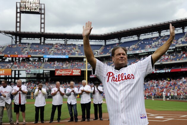 Former Philadelphia Phillies catcher Darren Daulton waves to the crowd as he takes the field during the Philadelphia Phillies Alumni ceremonies before a baseball game against the Atlanta Braves on Saturday, Aug. 3, 2013, in Philadelphia. (AP Photo/Michael Perez)