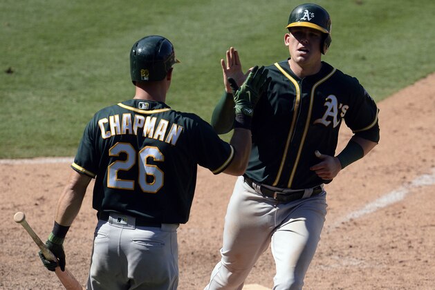 August 6, 2017; Anaheim, CA, USA; Oakland Athletics first baseman Ryon Healy (25) is greeted by third baseman Matt Chapman (26) after scoring a run in the eighth inning against the Los Angeles Angels at Angel Stadium of Anaheim. Mandatory Credit: Gary A. Vasquez-USA TODAY Sports
