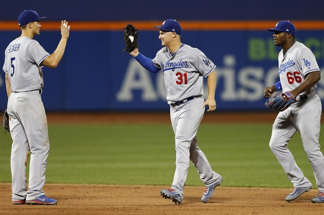 Aug 4, 2017; New York City, NY, USA; Los Angeles Dodgers shortstop Corey Seager (5) celebrates with  center fielder Joc Pederson (31) and right fielder Yasiel Puig (66) celebrate after defeating the New York Mets at Citi Field. Mandatory Credit: Noah K. Murray-USA TODAY Sports