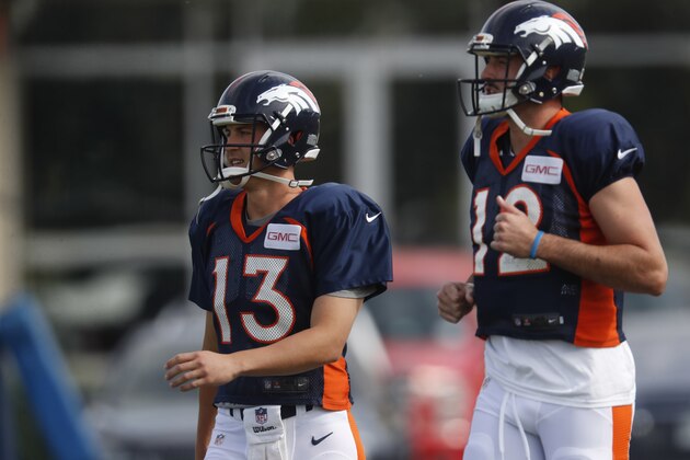 Denver Broncos quarterbacks Trevor Siemian, left, and Paxton Lynch takes part in drills at an NFL football training camp Sunday, July 30, 2017, in Englewood, Colo. (AP Photo/David Zalubowski)