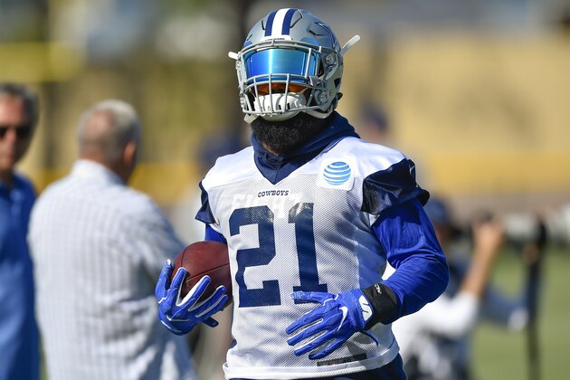 Dallas Cowboys running back Ezekiel Elliott runs the ball after a handoff during NFL football training camp in Oxnard, Calif., Tuesday, July 25, 2017. (AP Photo/Gus Ruelas)
